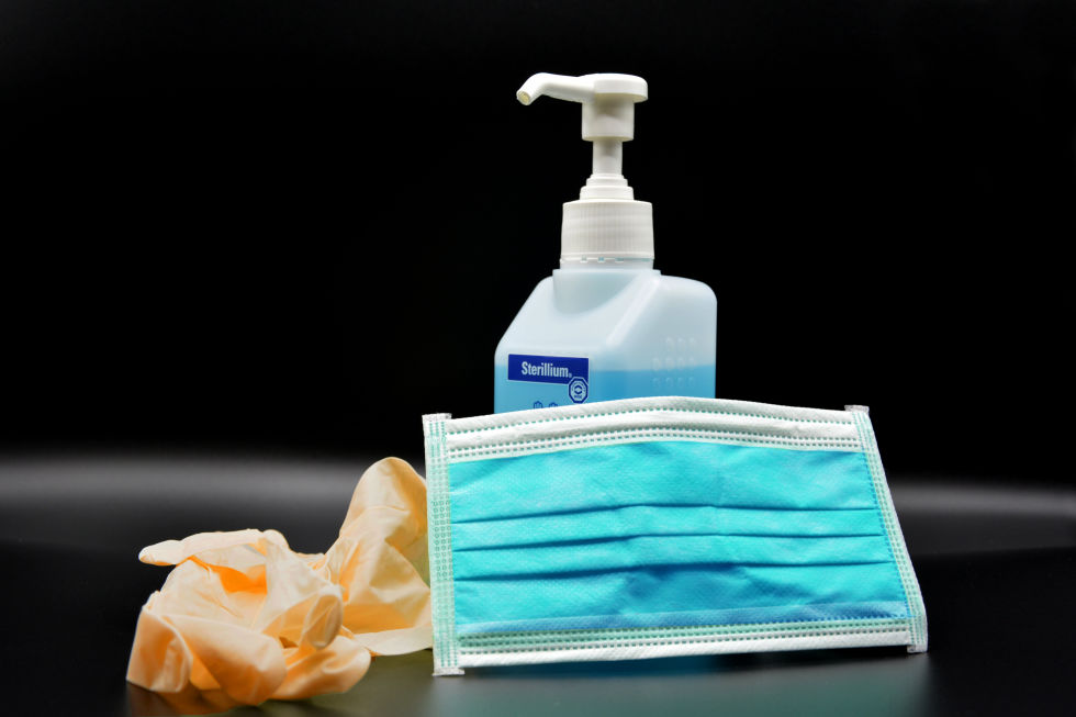 Gloves, face mask and sanitizer on a table