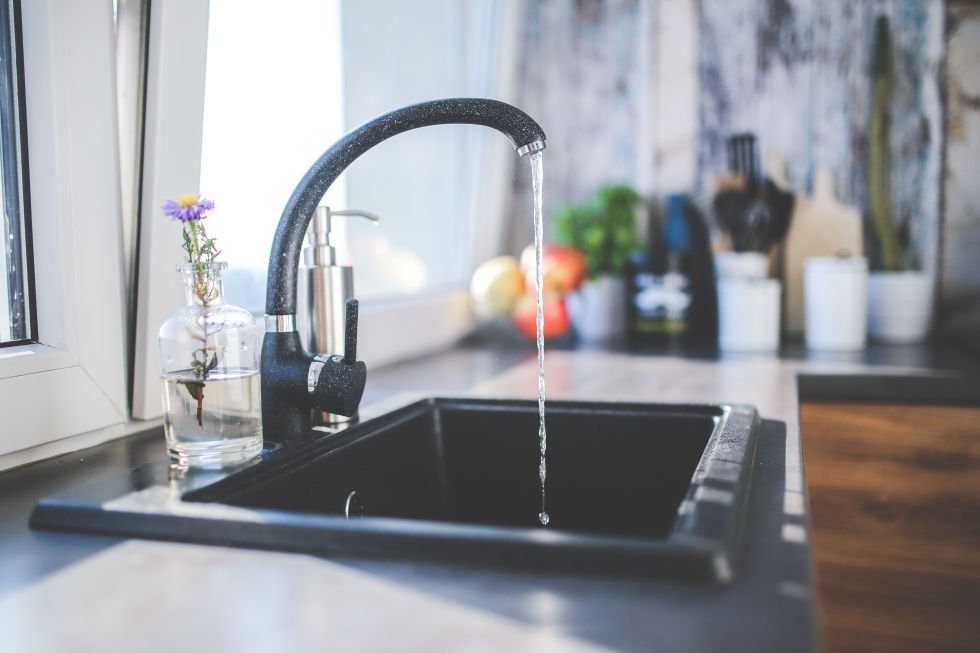 Water running from a faucet into sink