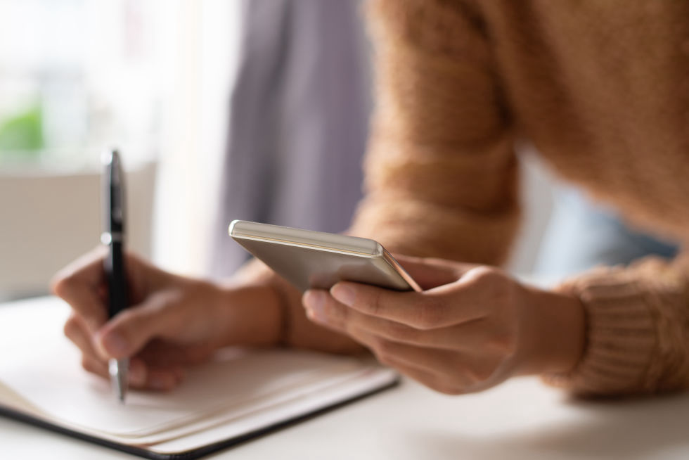 Women in-orange-sweater-on-smartphone